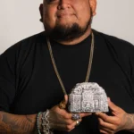 headshot of Jose Mendez holding an Indian relic