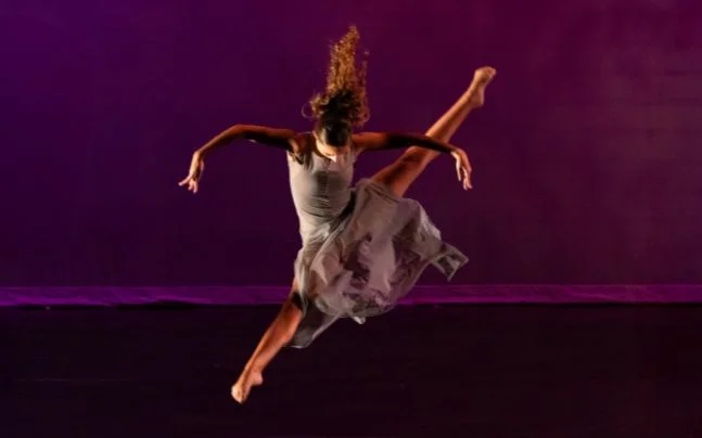 Dancer leaping across the stage