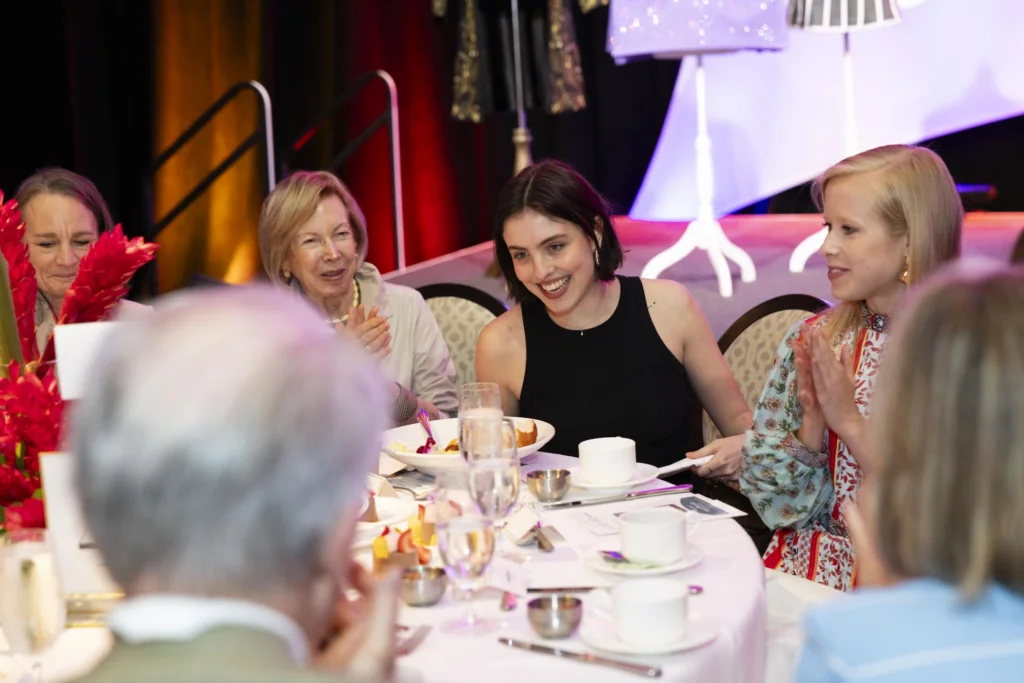 People sit around table at a luncheon.