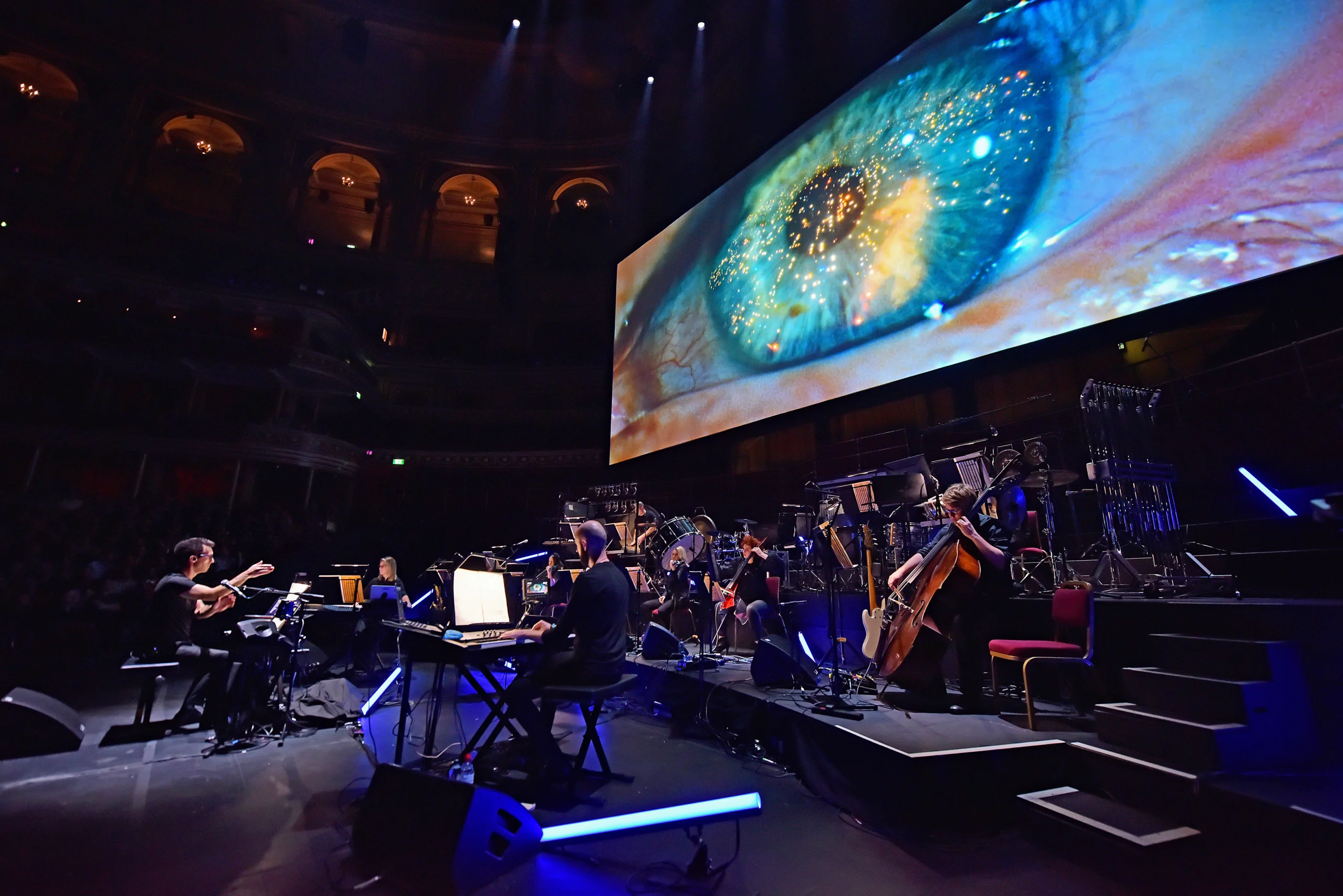 Screen above orchestra playing Blade Runner film.
