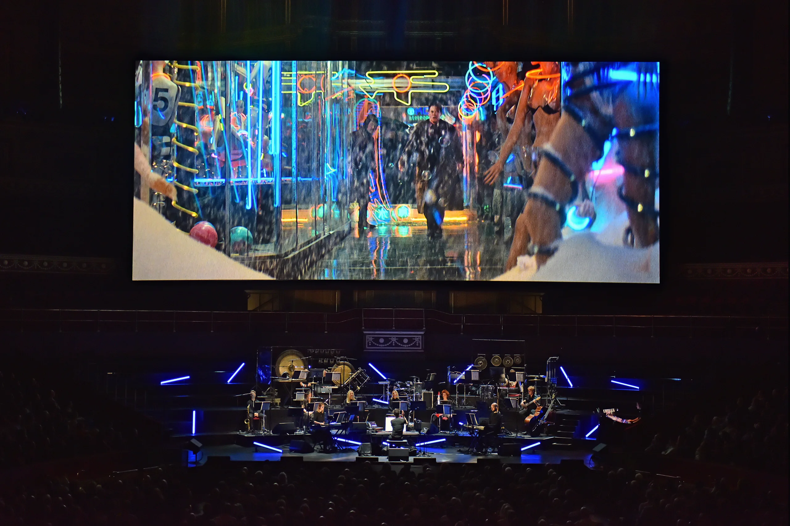 B Screen above orchestra playing scene from Blade Runner film