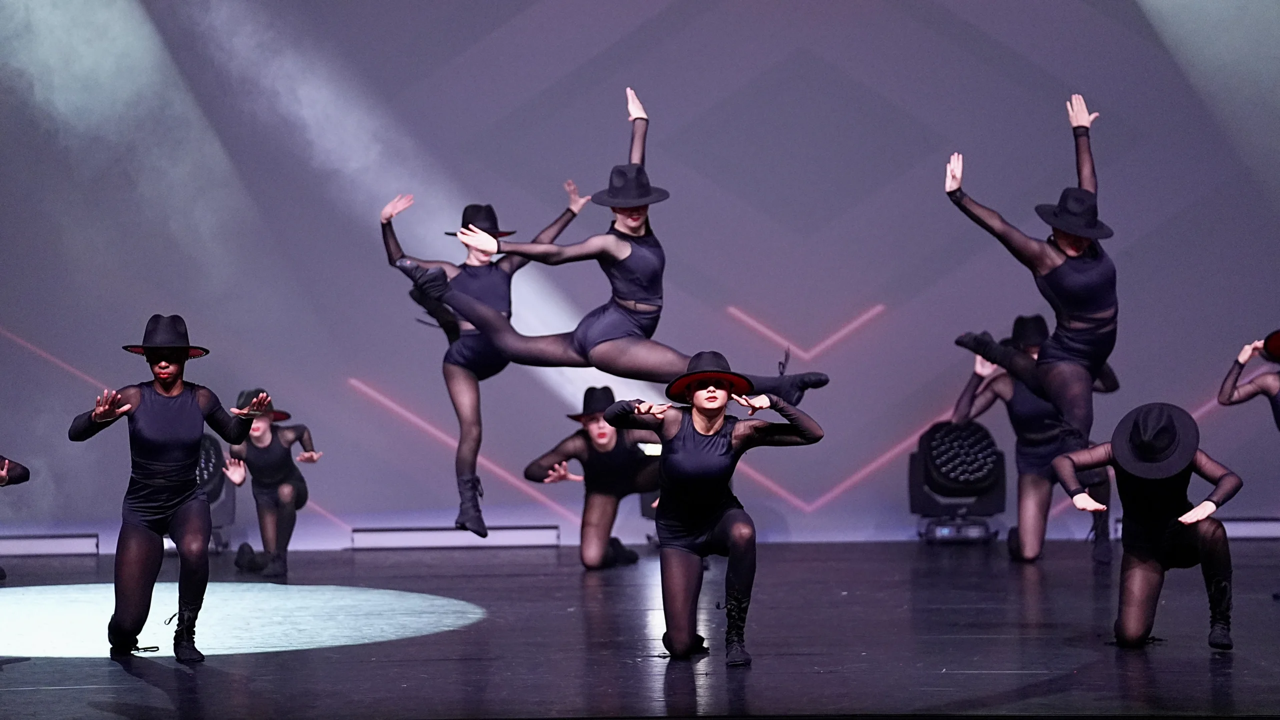 student dancers on stage in various poses.
