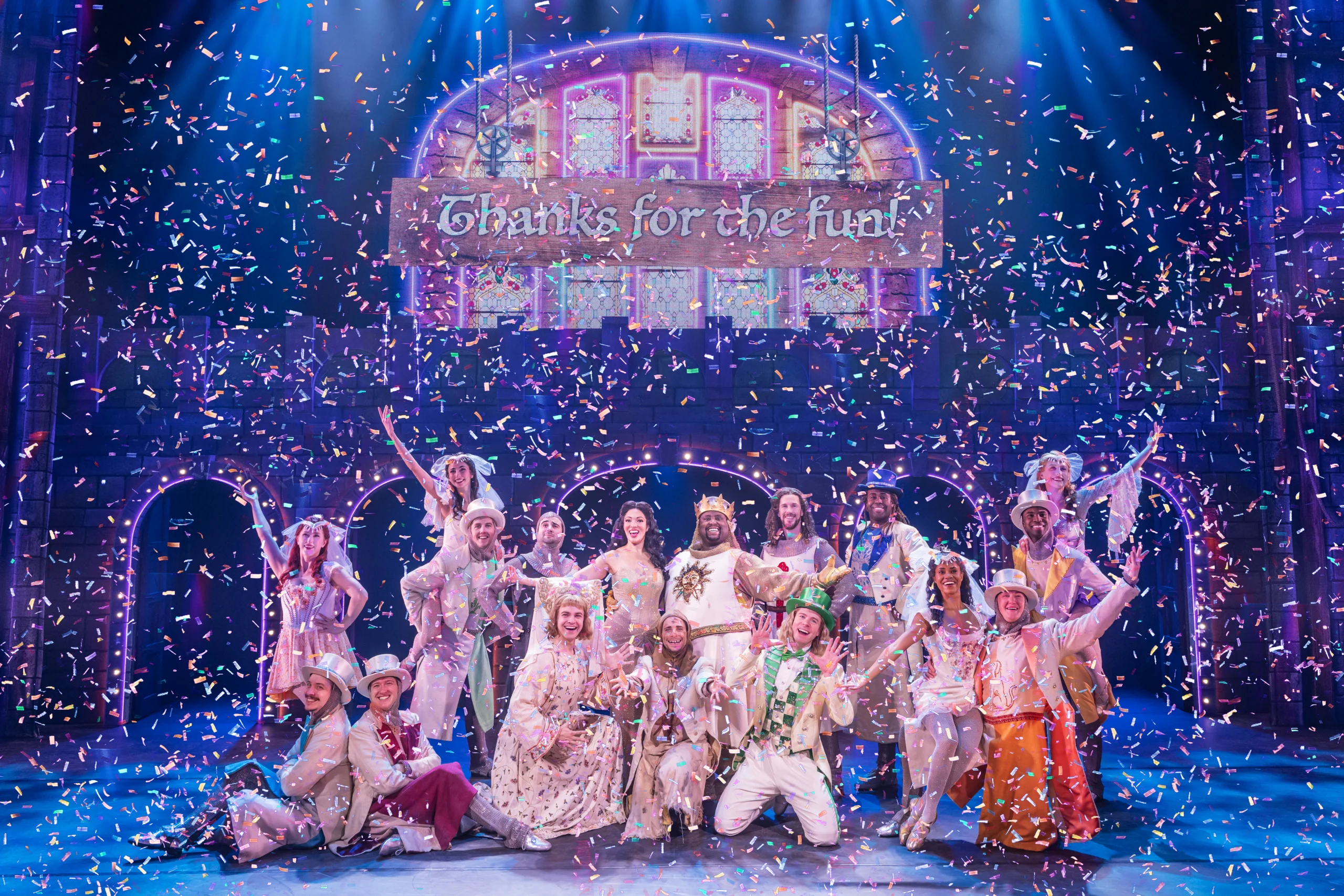 Cast in pose above sign reading 'thanks for the fun!' while colorful confetti falls.