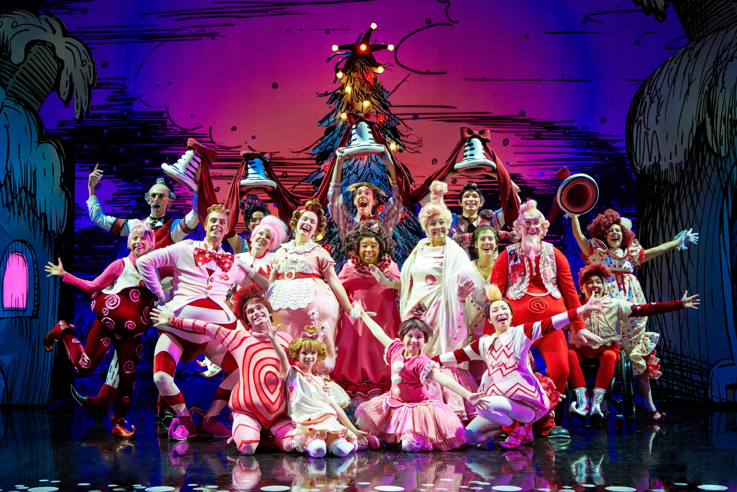 Cast cheerfully smiling in pose.