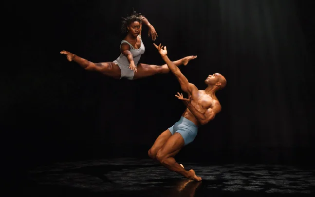 two dancers leap in pose.