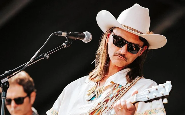 Duane Betts closeup of guitar playing in white shirt.