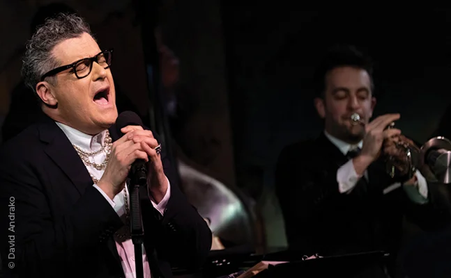 Isaac Mizrahi performs on stage.