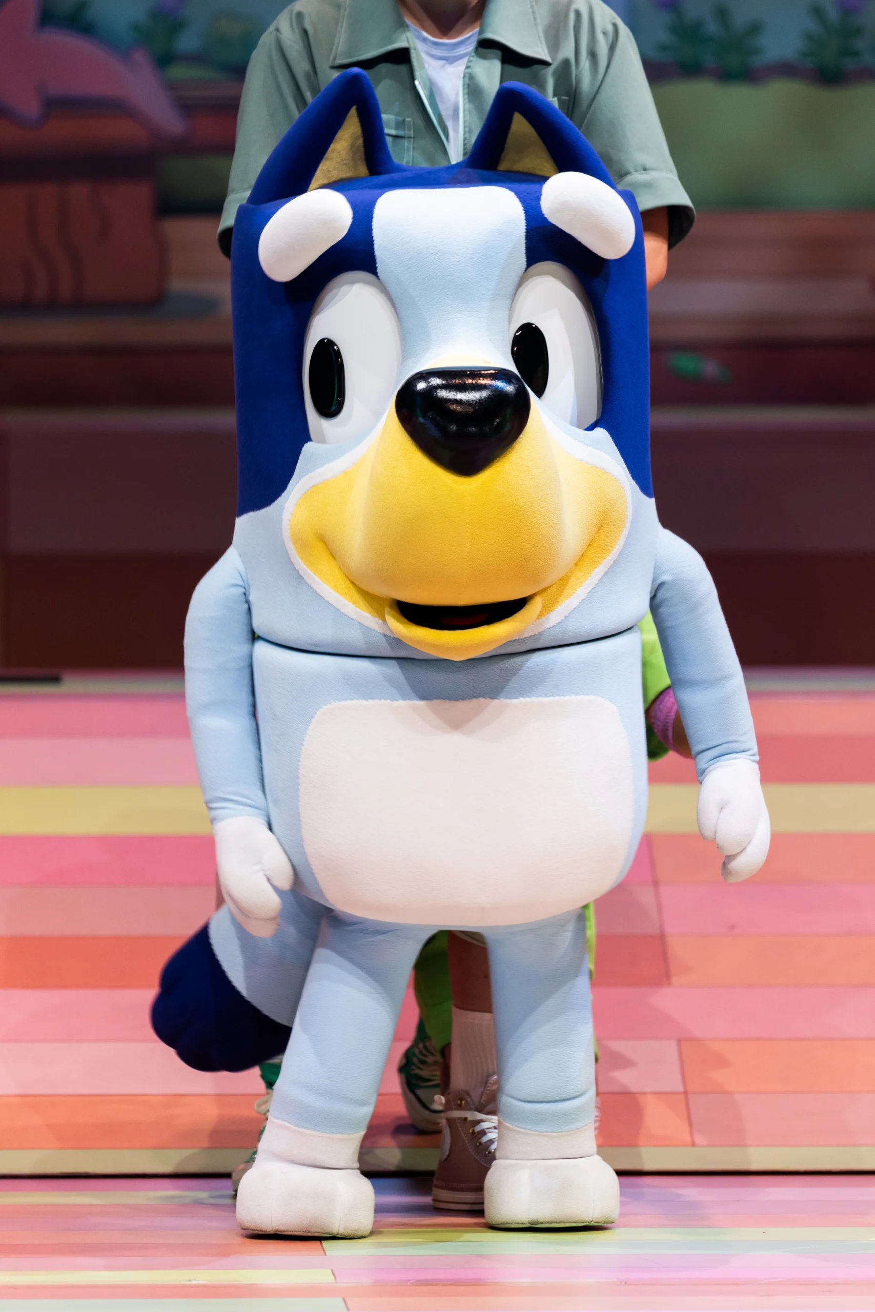 Bluey character puppet standing center stage during Bluey’s Big Play.