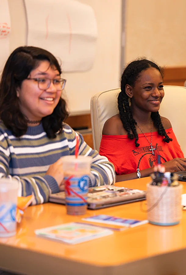 Participants seated at a table during a leadership and community engagement workshop.