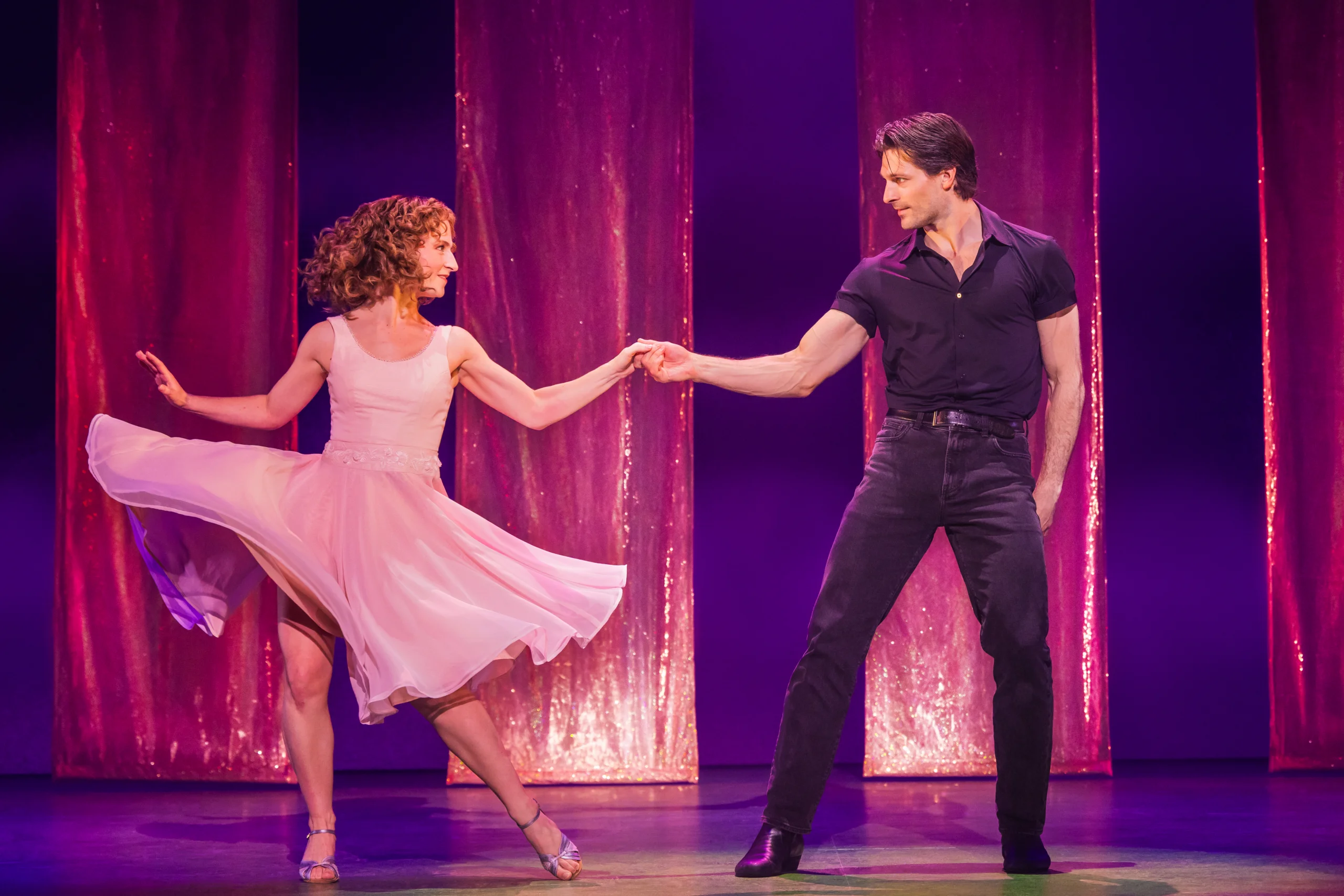 Dirty Dancing: The Musical promotional performance image featuring the show's lead characters in a romantic dance moment. Broadway musical event.