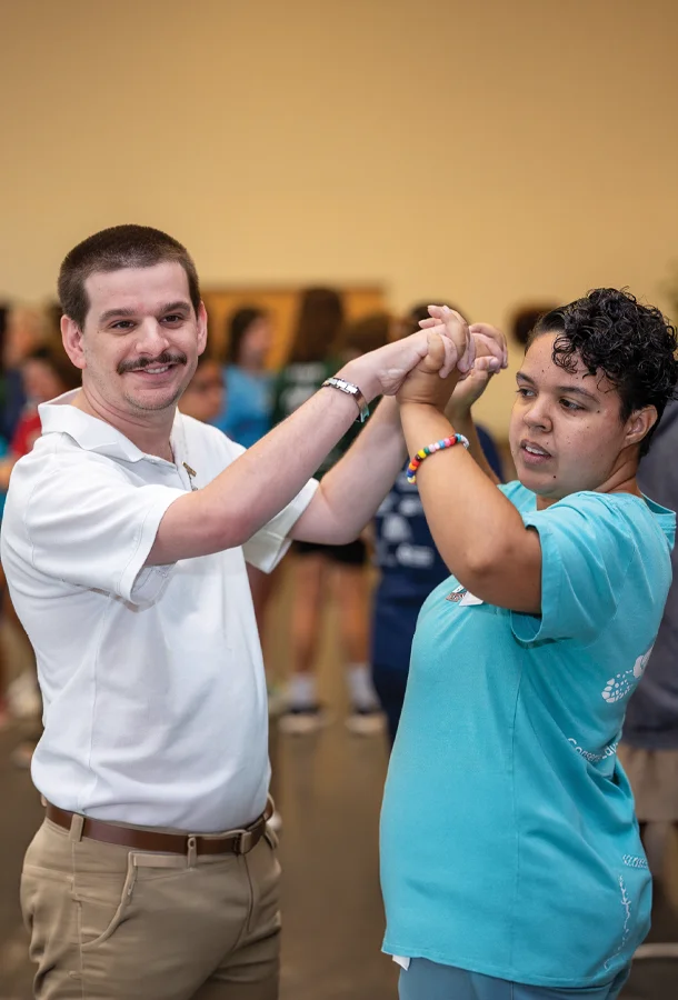 Two participants practicing a partner dance during an inclusive dance and movement program.
