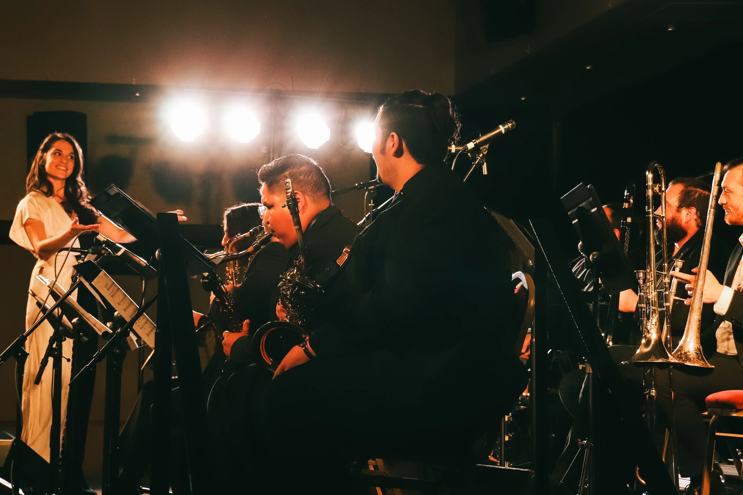Julia Keefe under the stage lights with band.