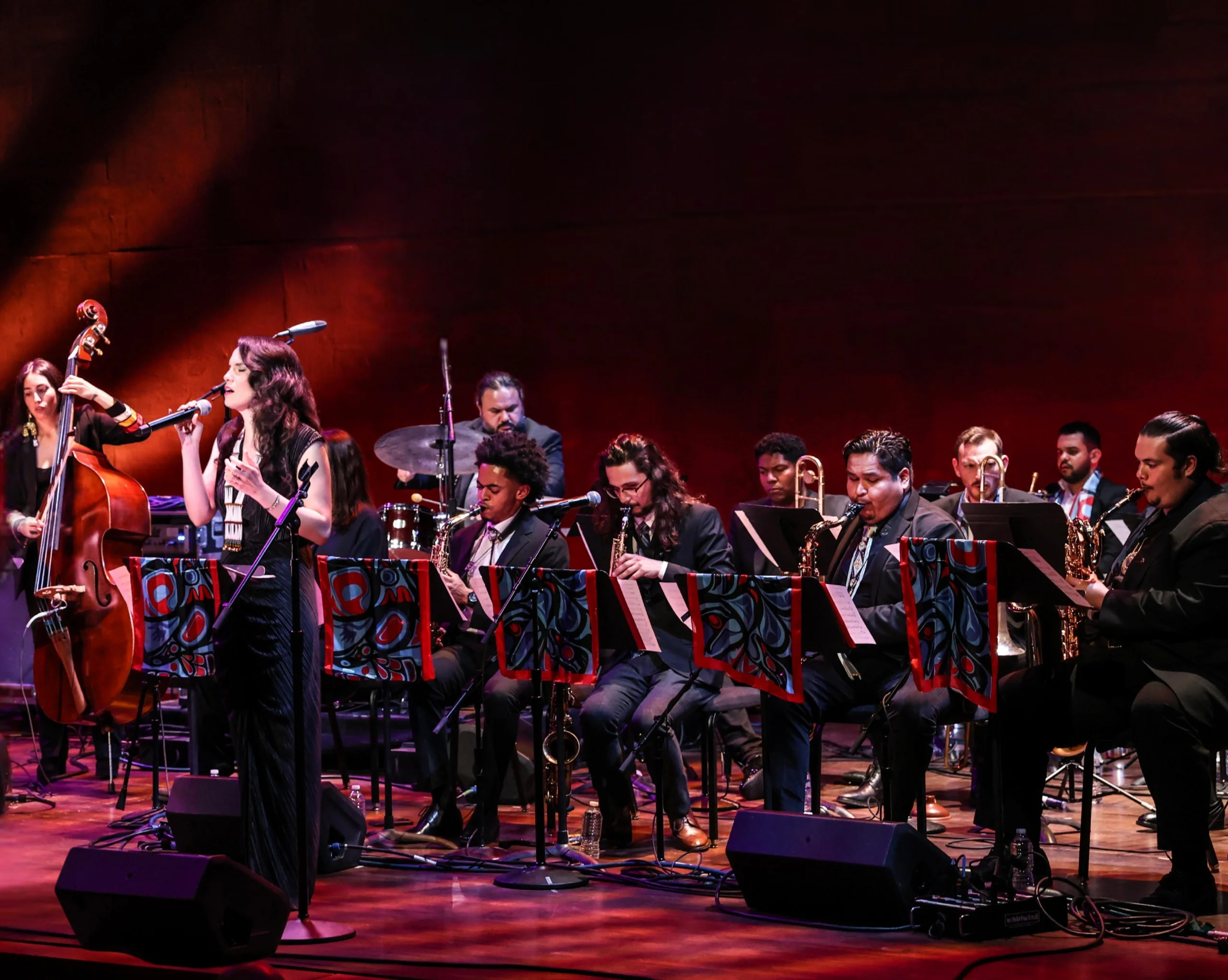 Julia Keefe sings in front of large orchestra.