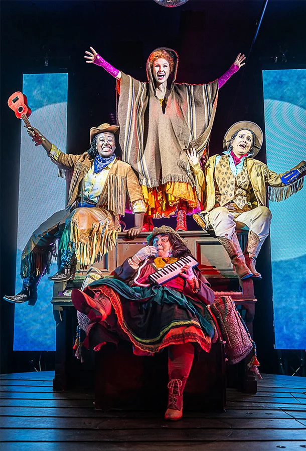 Performers in colorful costumes on stage during Musicians of Bremen Live! family theater production.