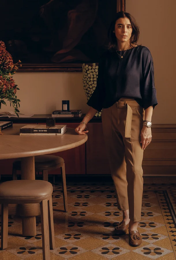 Professional portrait of interior designer Alessia Tihany standing beside a table in an elegant interior space. The image highlights design, architecture, and creative leadership.