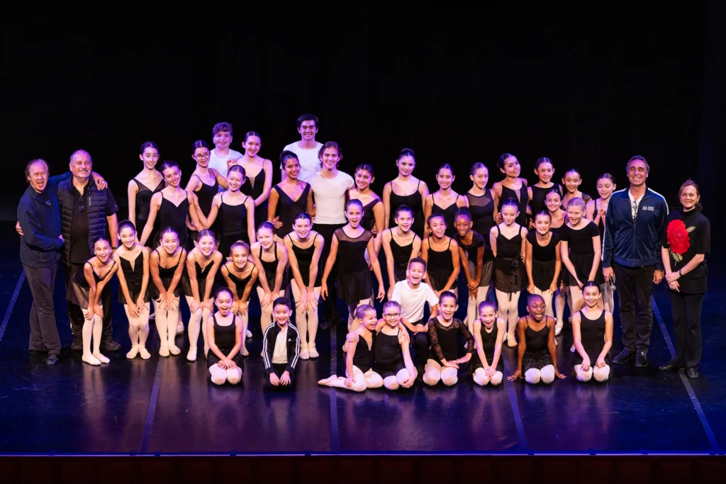 Magnifique 2026 Magnifique 2026 participants and instructors pose together on stage following a dance performance.